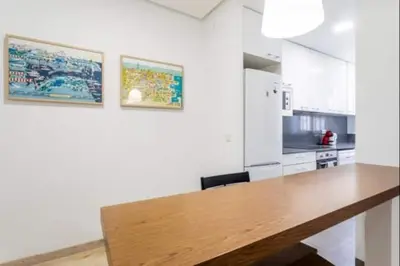 a large kitchen with a wooden table in a room at Centrico, 2 habitaciones, confort ascensor,wifi AC in Valencia