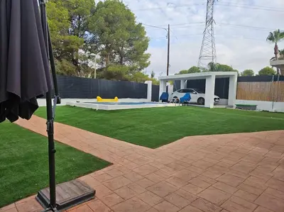 a yard with a house and a lawn with at La Cañada in Partida de La Cañada
