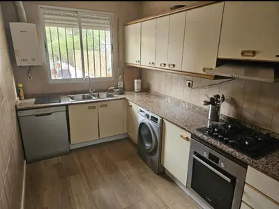 a kitchen with a washing machine and a sink at La Cañada in Partida de La Cañada