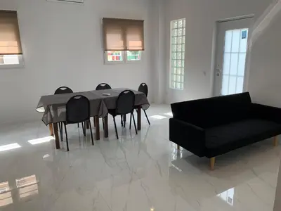 a living room with a table and chairs and a couch at Apartamento Sara - Alquiler de temporada in Puerto de Sagunto