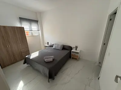 a bedroom with a bed in a white room at Apartamento Sara - Alquiler de temporada in Puerto de Sagunto