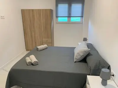 a bedroom with a large bed with two pillows on it at Apartamento Sara - Alquiler de temporada in Puerto de Sagunto