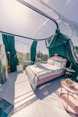 a master bedroom with a bed and a table at J&L Glamping in La Presa