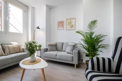 a living room with two couches and a table at SingularStays Santa Clara II in Valencia