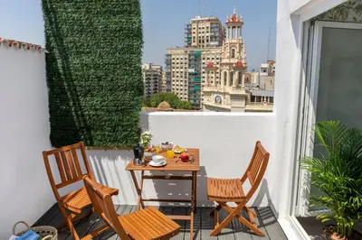 a table and chairs on a balcony with a view at SingularStays Santa Clara II in Valencia