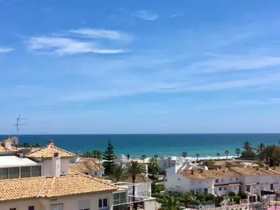 a view of a beach with houses and the ocean at Panorama Azul Apartment in El Puig