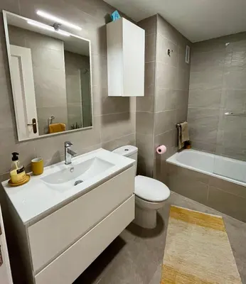 a bathroom with a sink and a toilet and a tub at Panorama Azul Apartment in El Puig