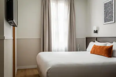 a bedroom with a white bed and a window at BYPILLOW Sinfonía in Valencia