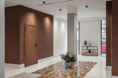 a lobby with a vase of flowers on a rug at BYPILLOW Sinfonía in Valencia