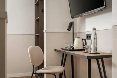 a kitchen with a table with a coffee maker on it at BYPILLOW Sinfonía in Valencia