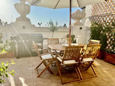 a table and chairs with an umbrella on a patio at Luxury penthouse center appartement in Valencia