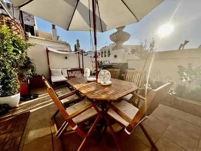 a table and chairs on a balcony with an umbrella at Luxury penthouse center appartement in Valencia