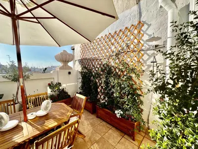 a patio with a table and an umbrella at Luxury penthouse center appartement in Valencia
