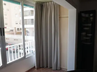 a room with a window with a view of a building at Malvarrosa, 1-6 in Cullera