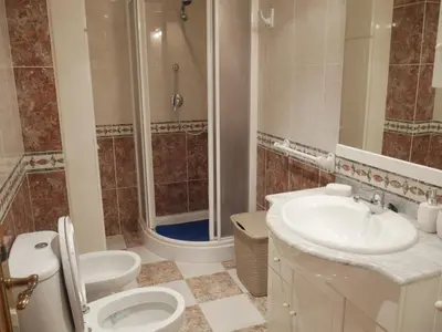 a bathroom with a shower and a toilet and a sink at Malvarrosa, 1-6 in Cullera