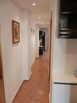 a hallway with white walls and a hallway with a hallway at Malvarrosa, 1-6 in Cullera