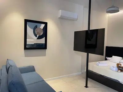 a living room with a couch and a bed at Osito Hub - Campoamor in Valencia
