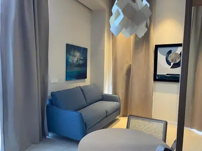 a living room with a blue couch and a table at Osito Hub - Campoamor in Valencia