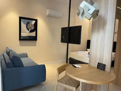 a living room with a blue couch and a table at Osito Hub - Campoamor in Valencia