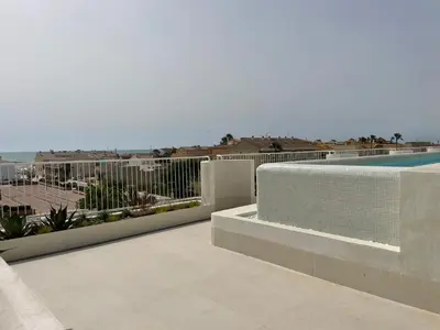 a balcony with a view of a swimming pool at Travel Habitat Playa Puzol con encanto in Puzol
