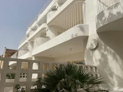 a white building with a staircase on the side of it at Travel Habitat Playa Puzol con encanto in Puzol