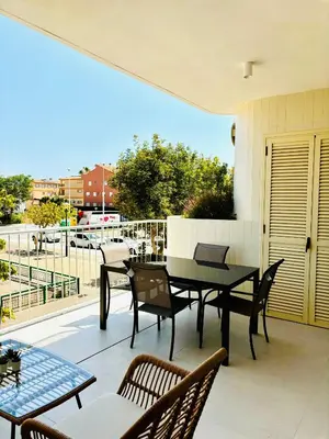 a patio with a table and chairs on a balcony at Travel Habitat Playa Puzol con encanto in Puzol