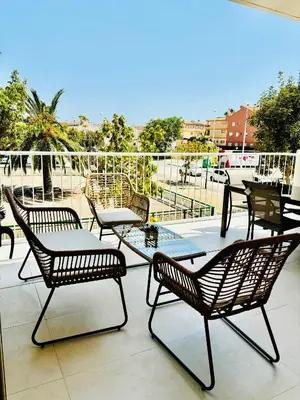 a group of chairs and tables on a patio at Travel Habitat Playa Puzol con encanto in Puzol