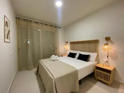 a bedroom with a large bed and a window at Travel Habitat Playa Puzol con encanto in Puzol