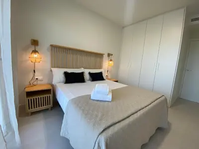 a bedroom with a large bed with a tray on it at Travel Habitat Playa Puzol con encanto in Puzol