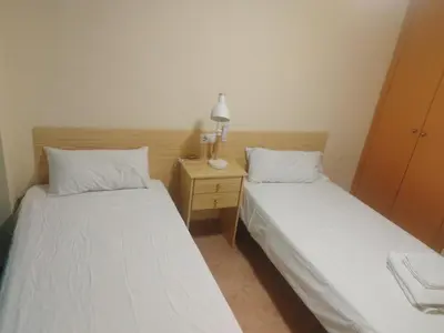 two beds sitting next to each other in a room at Apartamento cerca del puerto deportivo 1 in Burriana