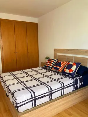 a bedroom with a large bed with two pillows at Cozy apartment near the beach in Puerto de Sagunto