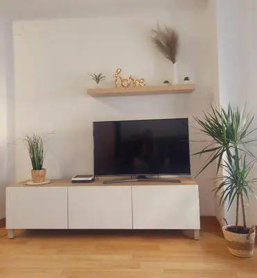 a white cabinet with a flat screen tv on top at Cozy apartment near the beach in Puerto de Sagunto