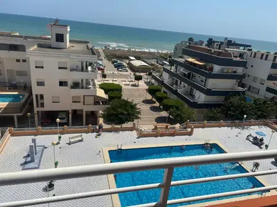 a view of a pool from the balcony of a resort at Appartement Tavernes de la Valldigna 4p in Valencia