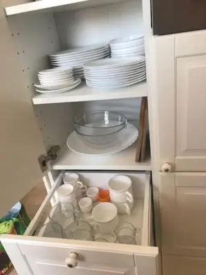 a cupboard with plates and dishes in it at Appartement Tavernes de la Valldigna 4p in Valencia