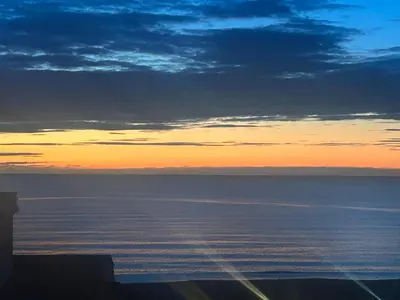 a view of the ocean at sunset at Appartement Tavernes de la Valldigna 4p in Valencia