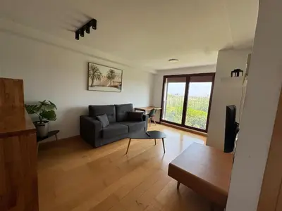 a living room with a couch and a table at New Loft park central, biopark in Valencia