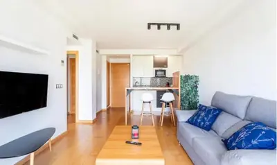 a living room with a couch and a table at New Loft park central, biopark in Valencia