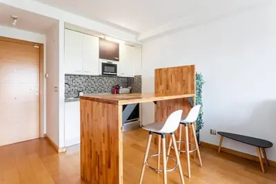 a kitchen with a counter and stools in a room at New Loft park central, biopark in Valencia