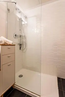 a bathroom with a shower with a glass door at New Loft park central, biopark in Valencia