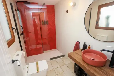 a bathroom with a red sink and a shower at Villa Valeria, Casa con Cueva privada del 1748 in Requena