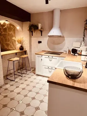 a kitchen with white cabinets and a counter top at Villa Valeria, Casa con Cueva privada del 1748 in Requena