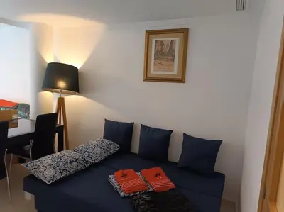 a blue couch with two pillows on it in a room at Gilet senderismo bici parking 20 min Valencia in Gilet