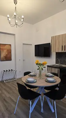 a kitchen and dining room with a table and chairs at Inspiracion Valencia in Valencia