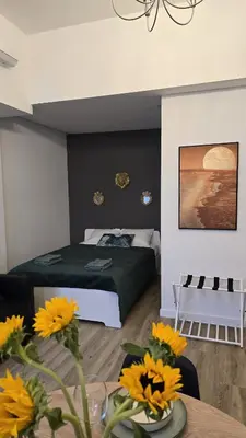 a bedroom with a bed and a table with flowers at Inspiracion Valencia in Valencia