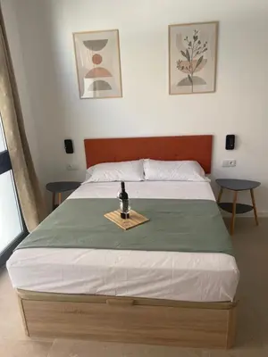 a bedroom with a bed with a tray on it at Galdós Flats by Vivo GC in Valencia