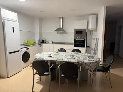 a kitchen with a table and chairs in a room at VIVIENDA La MERCED in El Puig