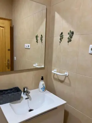 a bathroom with a sink and a mirror at VIVIENDA La MERCED in El Puig