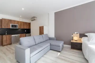 a living room with a couch and a bed at Albufera Dreams Nature Suites in Valencia