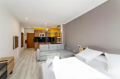 a living room with a bed and a couch at Albufera Dreams Nature Suites in Valencia