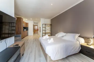 a bedroom with a large white bed with white pillows at Albufera Dreams Nature Suites in Valencia